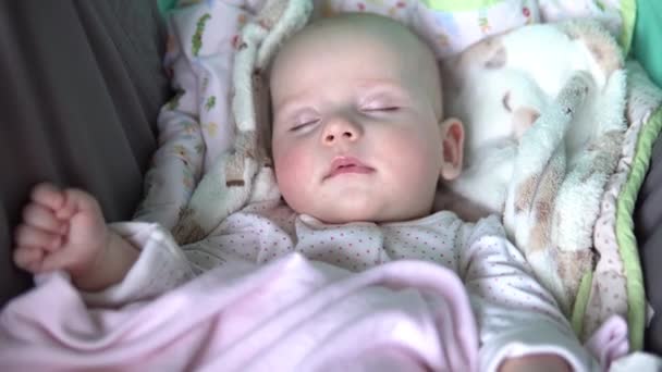 Ein Baby schläft mit Schnuller im Mund in einem Kinderwagen. Gesicht aus nächster Nähe. — Stockvideo