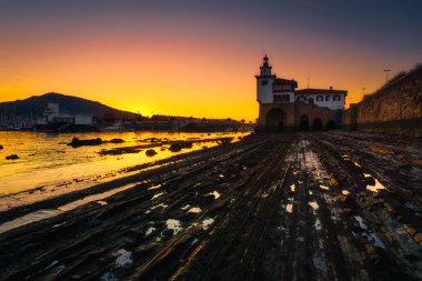 Arriluze lighthouse in Getxo at sunset clipart