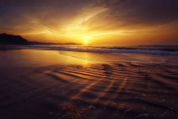 Sunset on beach with sun water reflections — Stock Photo, Image