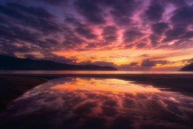 Plentzia beach with sky reflection on a puddle clipart