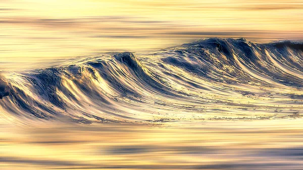 Blurry golden wave at sunset — Stock Photo, Image