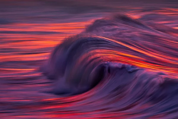Photo of wave water textures at sunset with in camera panning te — Stock Photo, Image