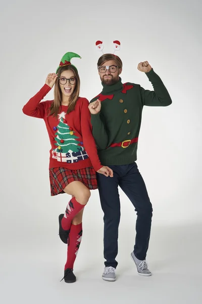 People in colorful christmas jumpers in funny holiday concept — Stock fotografie