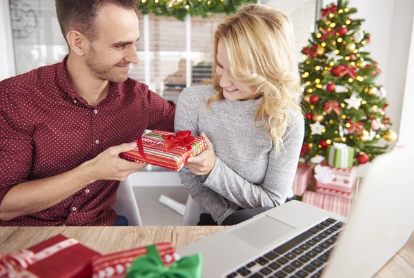 Couple of coworkers sharing their Christmas gifts