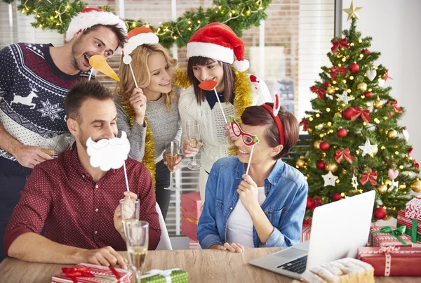 Group of workers are wearing Christmas accessories