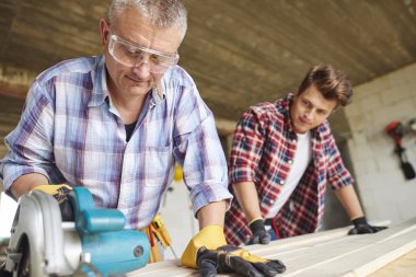two carpenters working together clipart