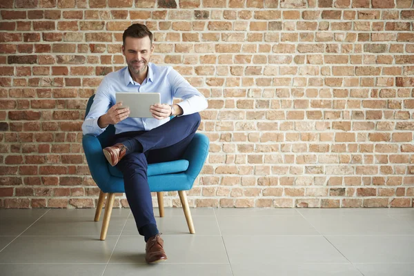 Empresario posando en sillón azul —  Fotos de Stock