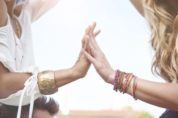 Two girls with bracelets on hands — Stock Photo, Image