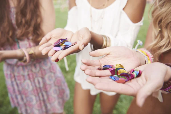 Lots of confetti on girls hands — Stock Photo, Image
