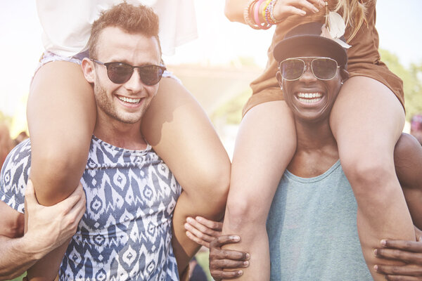 Portrait of men piggybacking women  