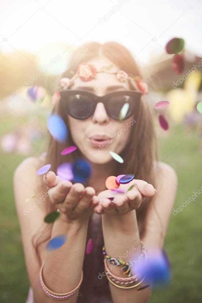 Colorful confetti blew by girl