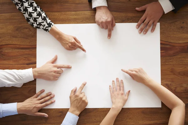 Human hands pointing at empty white card — Stock Photo, Image