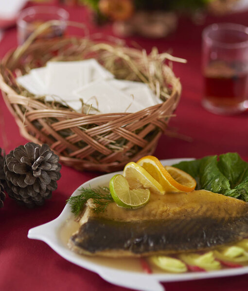 Delicious carp decorated with vegetables and citrus