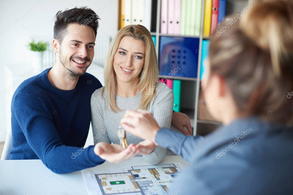 Young couple in sales office 