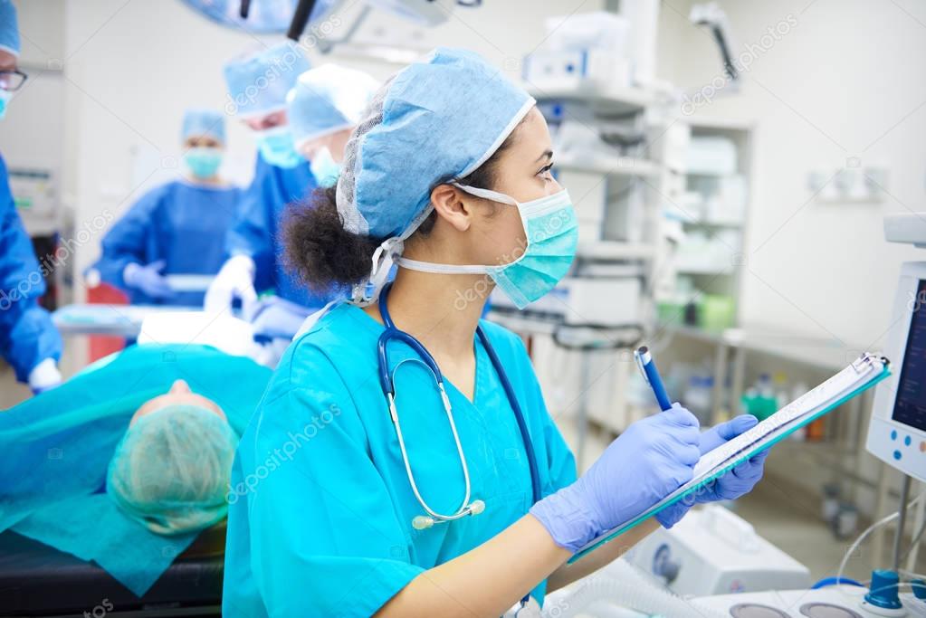 nurse writing down records 