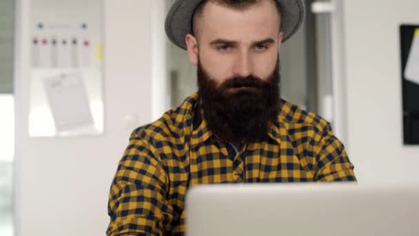 Thoughtful young man working on laptop — Stock Video