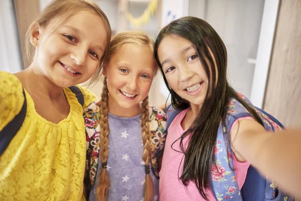 Little schoolgirls standing embracing — Stock Photo, Image