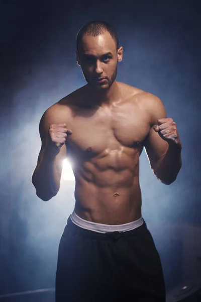 Young male athlete standing at gym — Stock Photo, Image