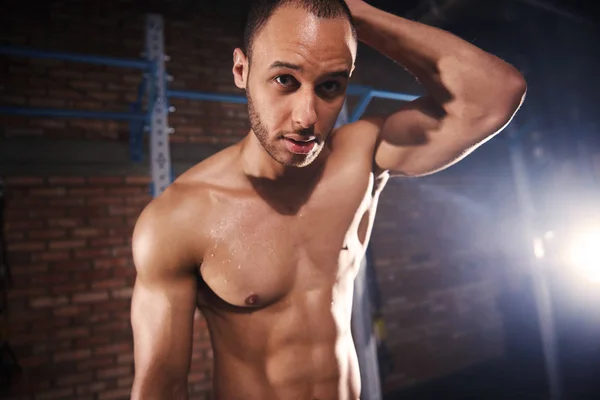 Young male athlete standing at gym — Stock Photo, Image