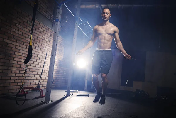 Sporty man working on jump rope — Stock Photo, Image