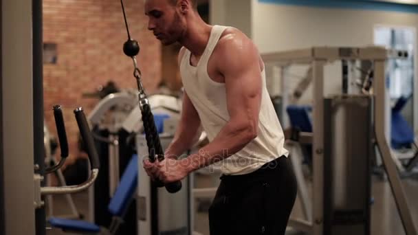 Man die zich uitstrekt over fitnessapparatuur — Stockvideo