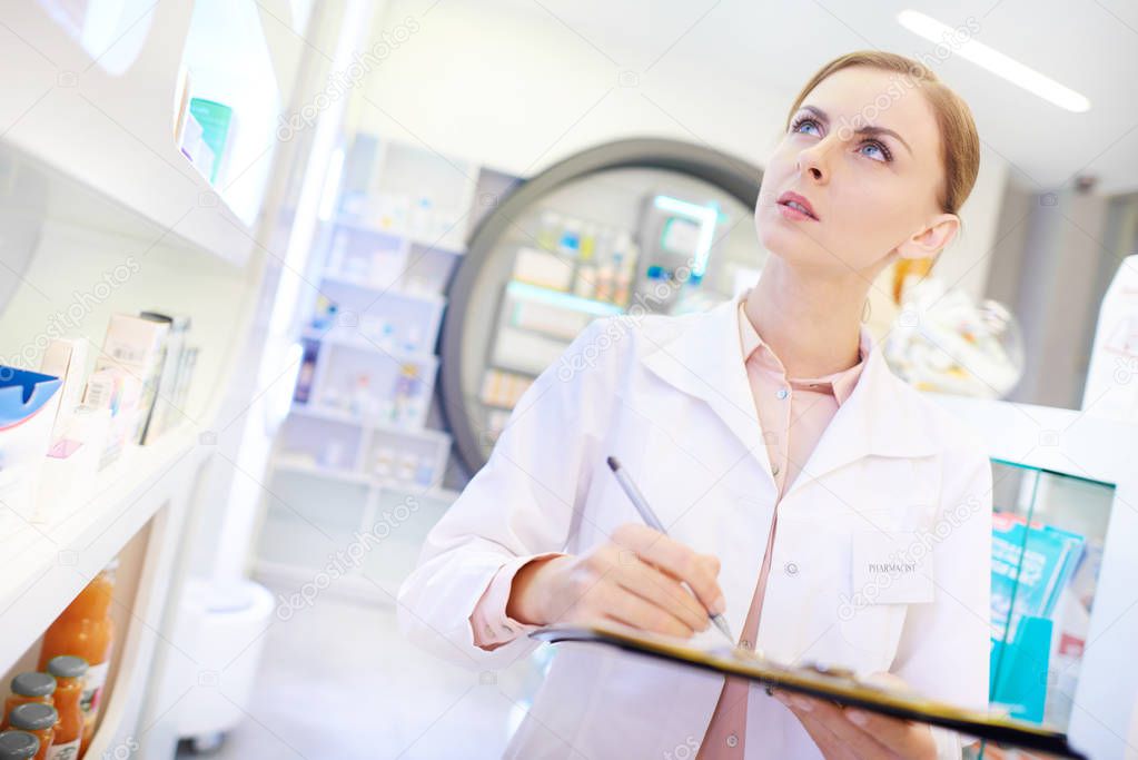 Apothecary taking inventory with clipboard 