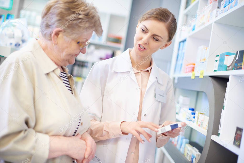 Professional pharmacist explaining prescription