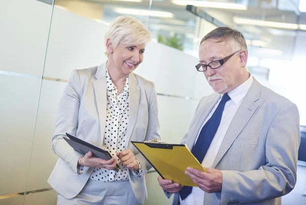 Senior-Geschäftspaar beim Vergleich von Dokumenten — Stockfoto