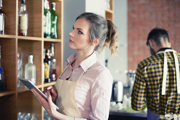 Waitress ordering products by digital tablet — Stock Photo, Image