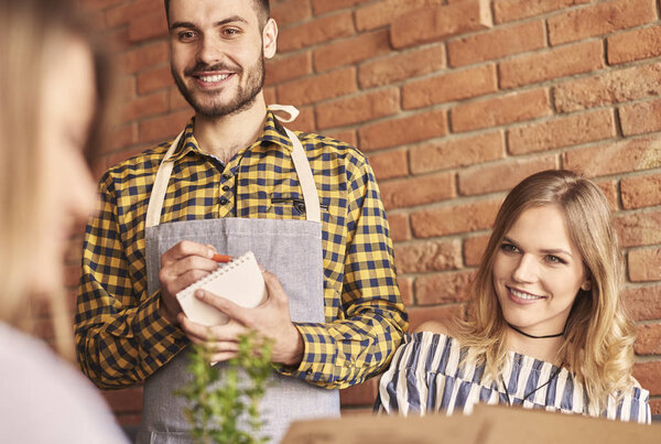 Waiter taking an order from client