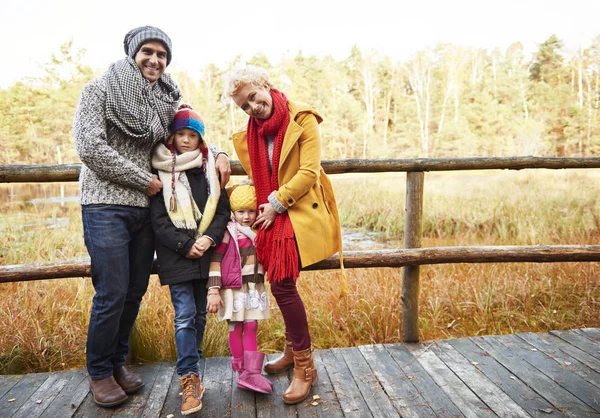 Family posing on wooden bridge — Stock Photo, Image