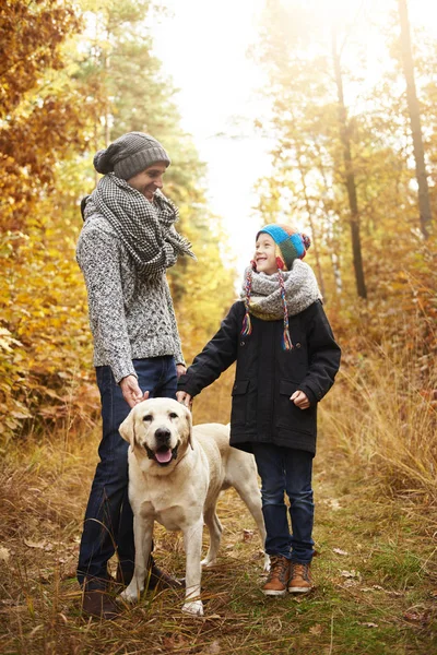 Father and son looking after their pet — Stock Photo, Image