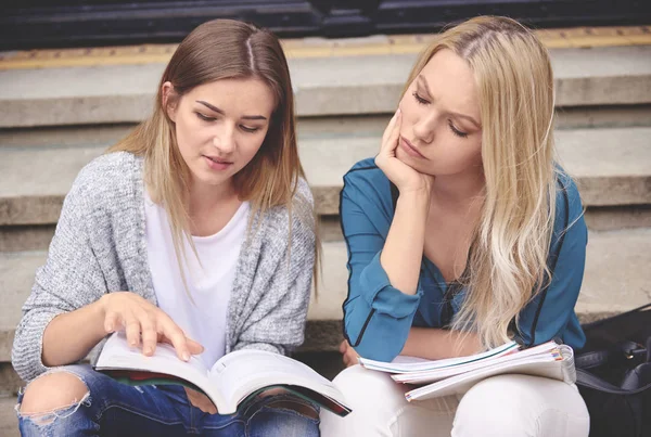 Studentka přátele, jak sedí na schodech — Stock fotografie