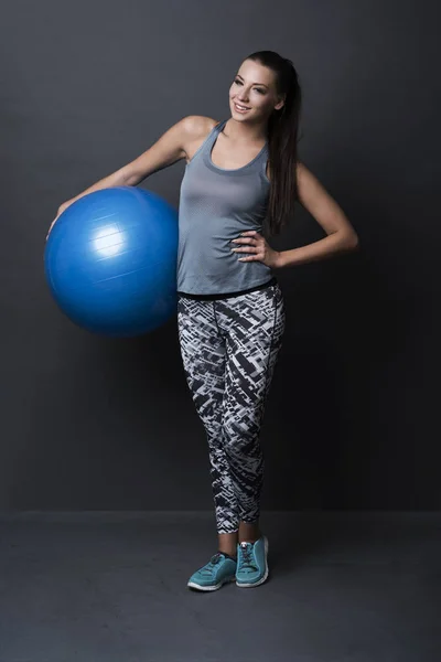 woman holding fit ball