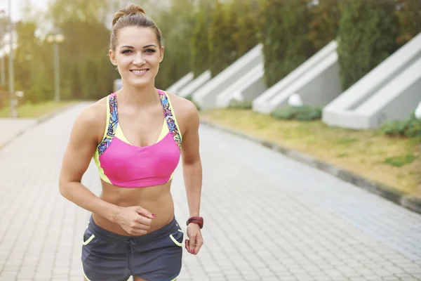 Sportive woman jogging outdoors — Stock Photo, Image