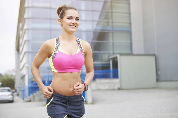 Sportive woman jogging outdoors — Stock Photo, Image