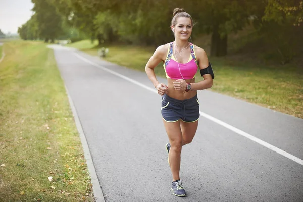 Sportive woman jogging outdoors — Stock Photo, Image