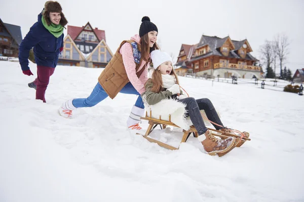 Mother and daughter sledding — Stock Photo, Image