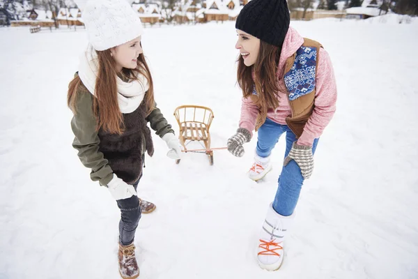 Mother and daughter sledding — Stock Photo, Image