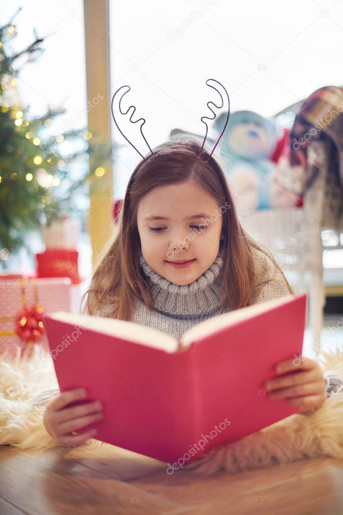 Little girl reading book 