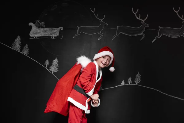 Menino em traje de Papai Noel — Fotografia de Stock