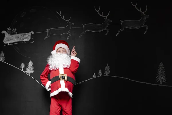 Menino em traje de Papai Noel — Fotografia de Stock