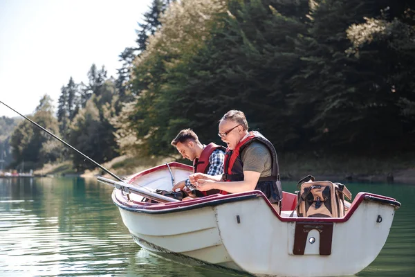 men fishing from rowboat