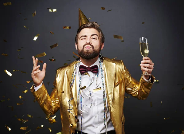 Man with champagne blowing lips