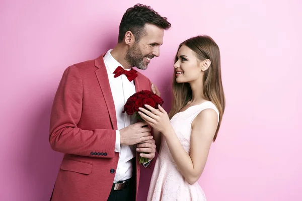 Enamored man with bunch of rose flirting — Stock Photo, Image