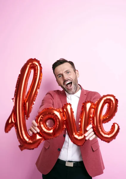 Man with helium balloon shouting love you — Stock Photo, Image