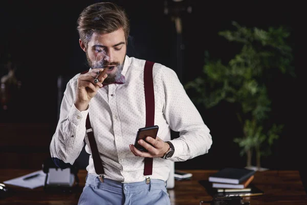 Bonito homem fumar charuto cubano e ler mensagem de texto — Fotografia de Stock
