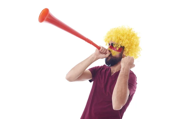 Soccer fan with wig and vuvuzela celebrating — Stock Photo, Image