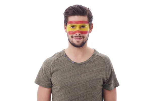 Portret van vrolijke man met Spaanse vlag op gezicht — Stockfoto