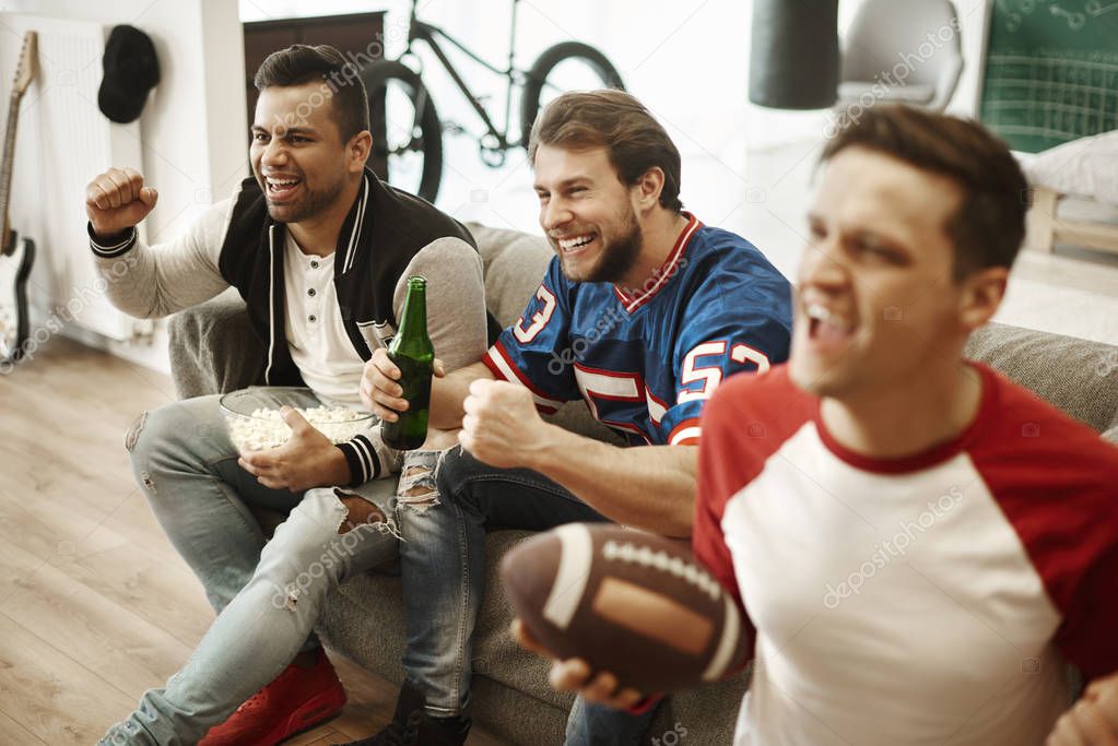 Excited football fans watching american football